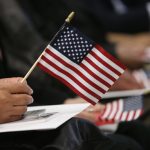 NEW YORK, NY - JANUARY 17:  Immigrants wait for a naturalization ceremony held at the U.S. Citizenship and Immigration Services (USCIS) office on January 17, 2014 in New York City. One hundred and fifty-three people from 41 countries became American citizens at the event.  (Photo by John Moore/Getty Images)